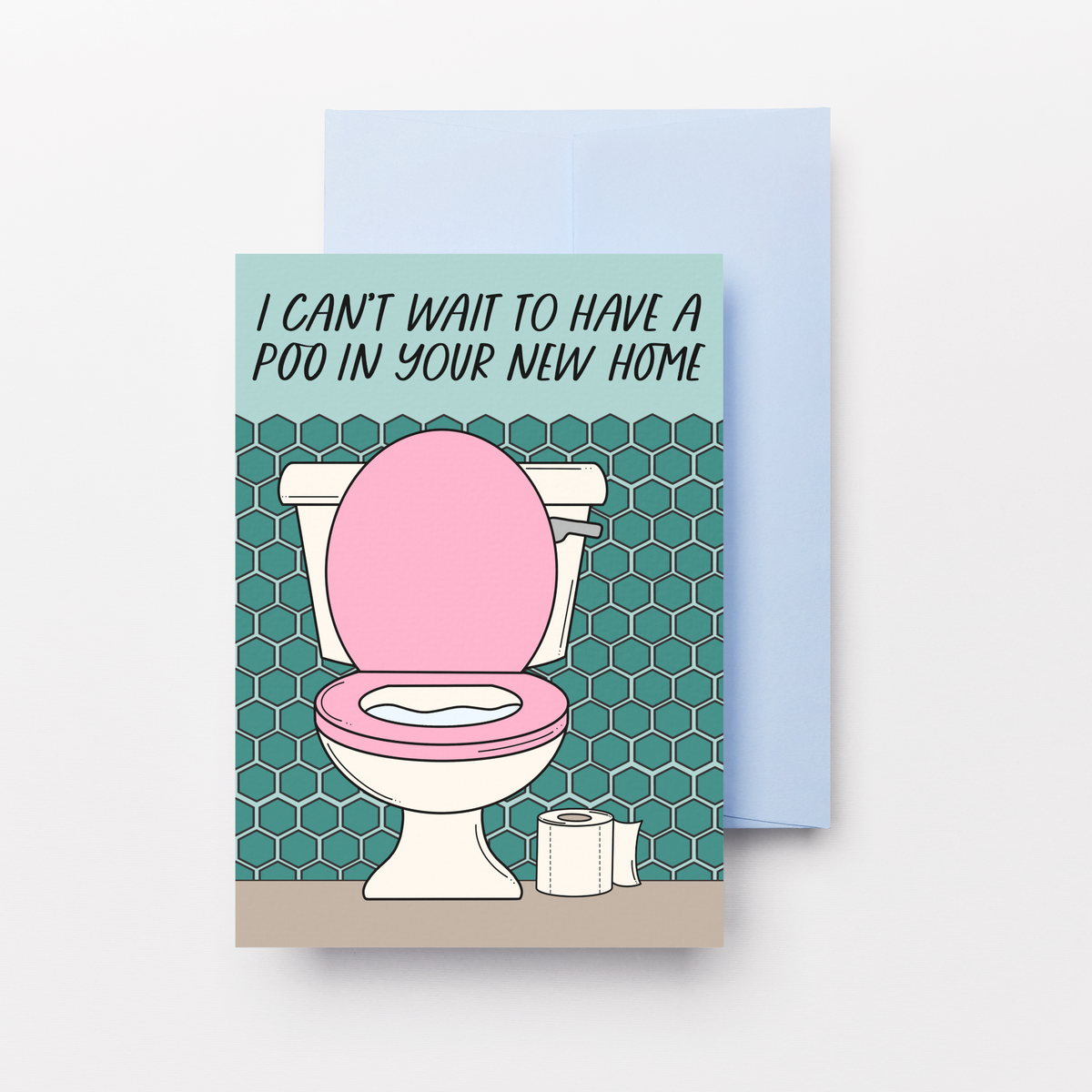 A rectangular greeting card with a light blue envelope behind it, shown on a plain light background. The card features a cartoon toilet with a pink lid and seat, teal tiled walls, and the text, 'I CAN'T WAIT TO HAVE A POO IN YOUR NEW HOME!'.