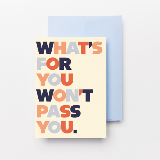 A cream greeting card with the phrase 'WHAT'S FOR YOU WON'T PASS YOU.' in stacked multicolor letters, shown with a light blue envelope behind it on a white background.