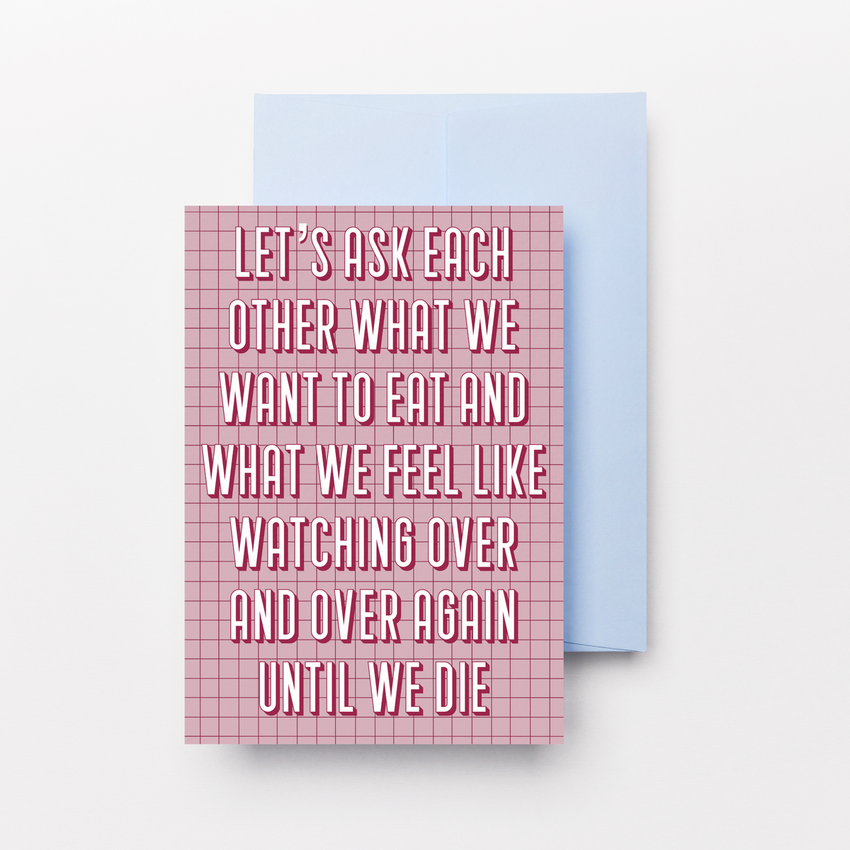 A pink and white gingham patterned greeting card with white text reading 'LET'S ASK EACH OTHER WHAT WE WANT TO EAT AND WHAT WE FEEL LIKE WATCHING OVER AND OVER AGAIN UNTIL WE DIE', shown with a light blue envelope behind it on a white background.