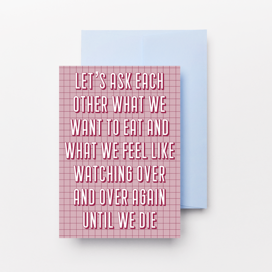 A pink and white gingham patterned greeting card with white text reading 'LET'S ASK EACH OTHER WHAT WE WANT TO EAT AND WHAT WE FEEL LIKE WATCHING OVER AND OVER AGAIN UNTIL WE DIE', shown with a light blue envelope behind it on a white background.