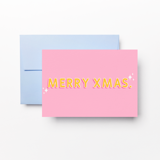 A pink greeting card with yellow text reading 'MERRY XMAS.' and small white sparkle accents, shown in front of a light blue envelope on a clean white background.