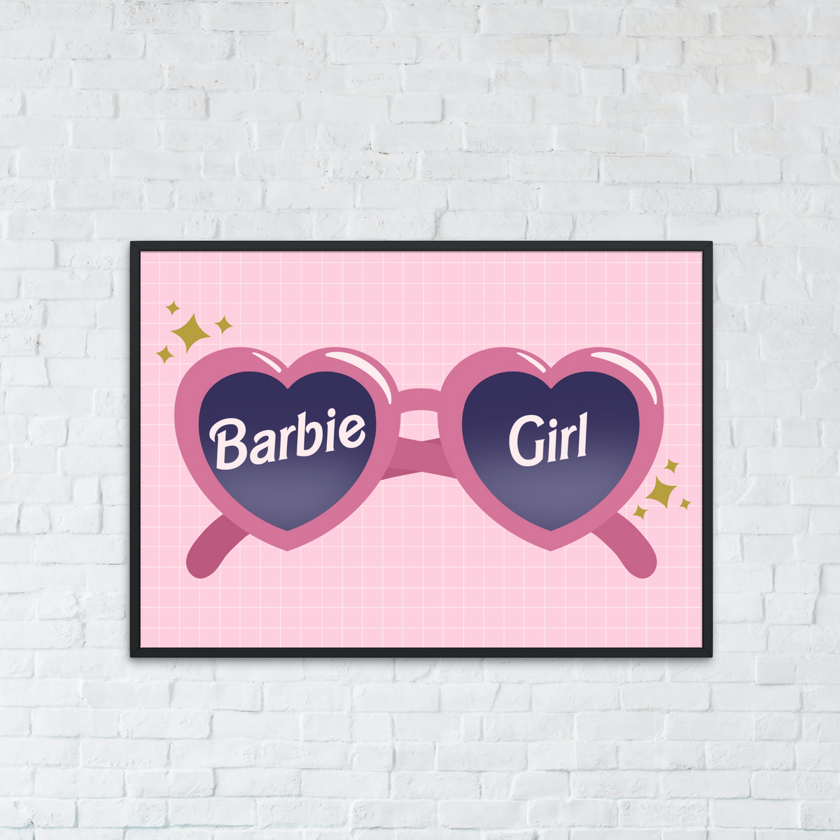 A framed wall art print featuring pink heart-shaped sunglasses with the words 'Barbie Girl' on the lenses, displayed on a white brick wall above a teal sofa.